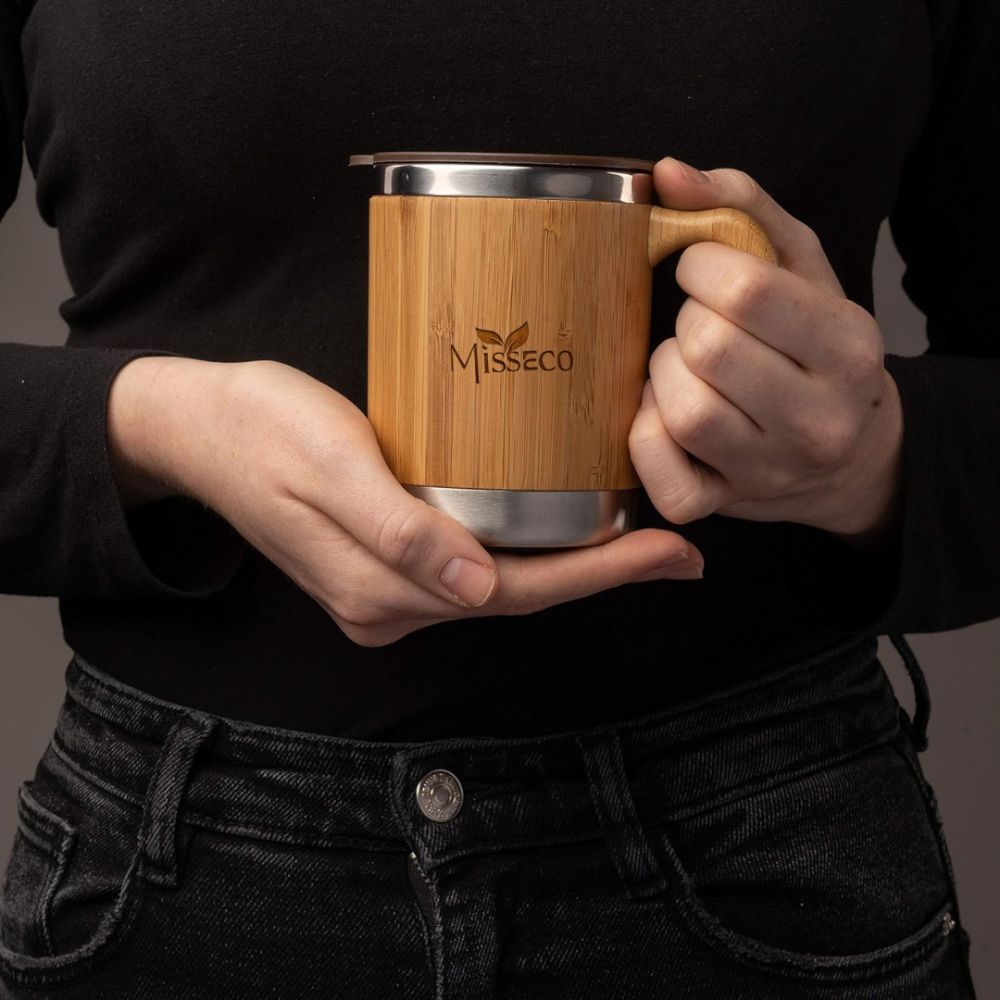 bamboo coffee mug in hand